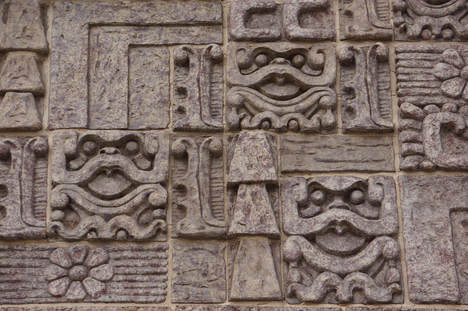 A picture of Mayan hieroglyphics carved from stone. 