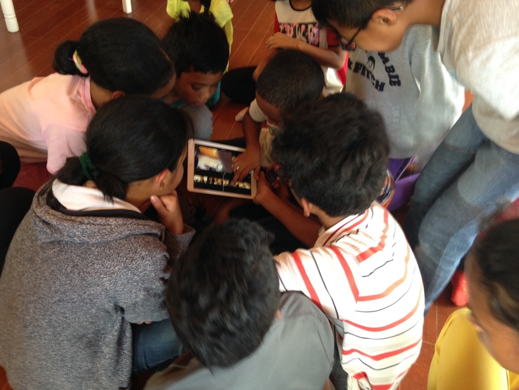 Middle school kids working on a video on the iPad purchased with Wenner Gren funding for our cultural exchange.